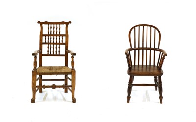 Lot 245 - An early 20th century rush seat spindle back elbow chair and a Victorian child's Windsor chair.