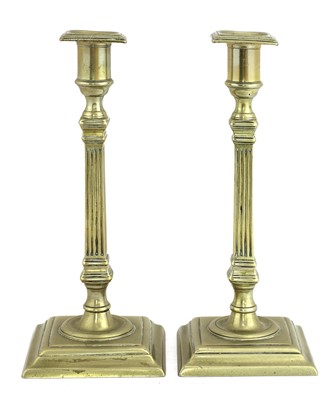 Lot 937 - A pair of George III Paktong candlesticks