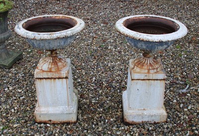 Lot 675 - Pair of white painted cast iron garden urns