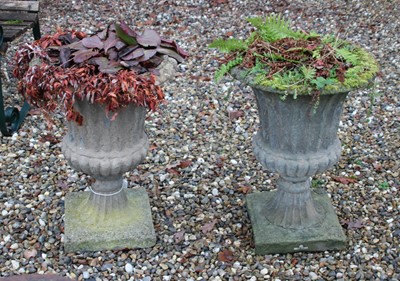 Lot 680 - A pair of reconstituted stone campana form garden urns