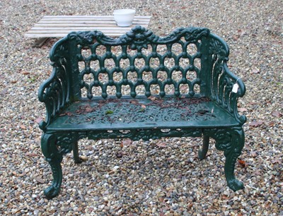Lot 682 - A green painted cast iron ‘horseshoe’ garden bench