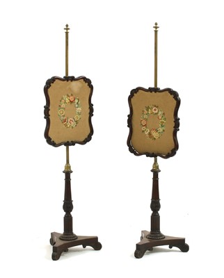 Lot 394 - A pair of Victorian rosewood pole screens