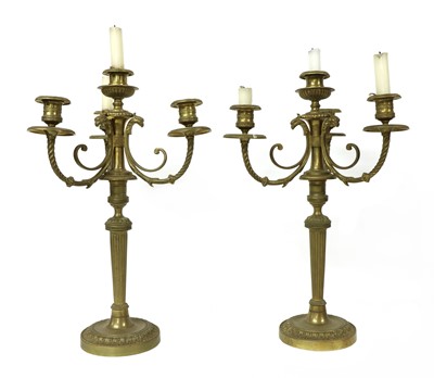 Lot 57 - A pair of brass three-branch candelabrum