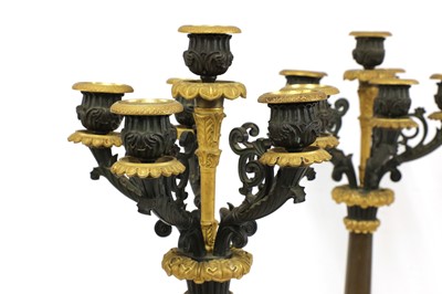 Lot 32 - A pair of French Empire bronze and parcel gilt candelabrum