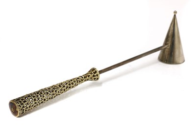 Lot 407 - A silver gilt candle snuffer