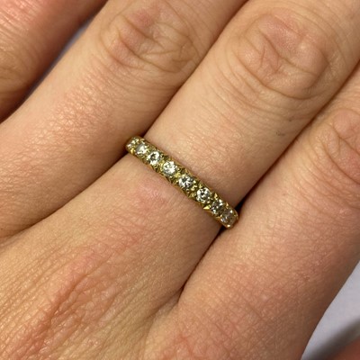 Lot 127 - An 18ct gold diamond half eternity ring