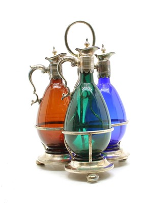 Lot 91 - Three coloured glass claret jugs