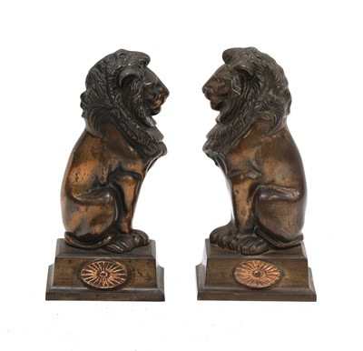 Lot 229 - A pair of lion fire dog ornaments