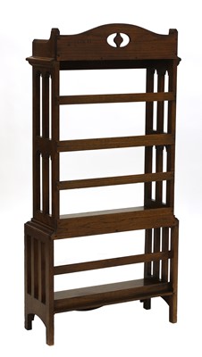 Lot 33 - An Arts and Crafts oak four-tier open bookcase