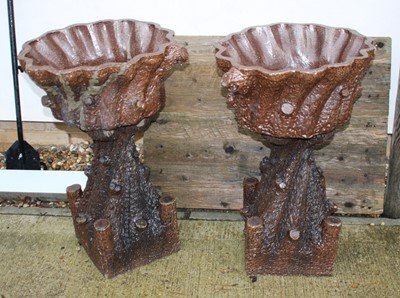 Lot 674 - A pair of stoneware urns on stands