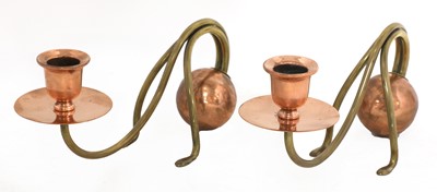 Lot 38 - A pair of Arts and Crafts copper and brass candlesticks
