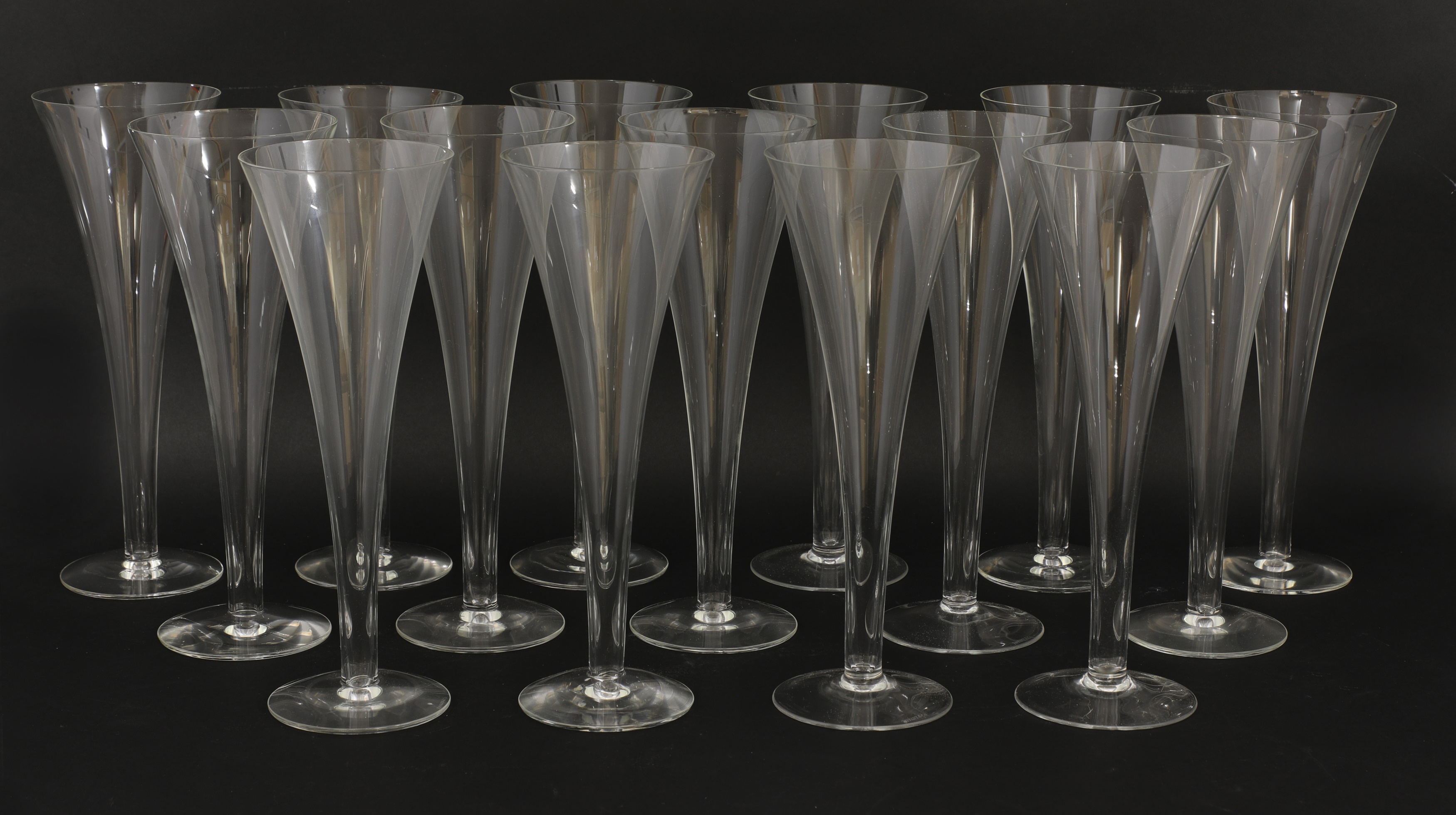 Lot 540 A set of fifteen modern champagne flutes,