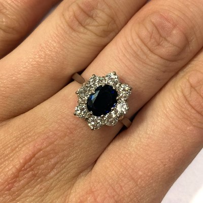 Lot 106 - A platinum sapphire and diamond cluster ring