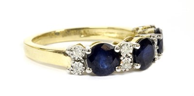 Lot 147 - A gold eleven stone sapphire and diamond ring