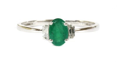 Lot 142 - A white gold emerald and diamond three stone ring