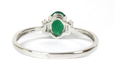 Lot 142 - A white gold emerald and diamond three stone ring