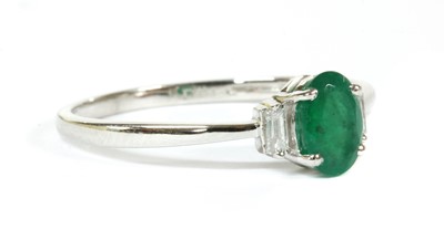 Lot 142 - A white gold emerald and diamond three stone ring