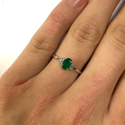 Lot 142 - A white gold emerald and diamond three stone ring