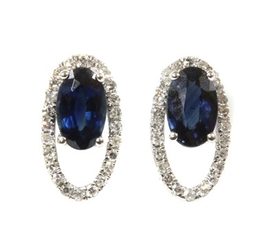 Lot 112 - A pair of white gold sapphire and diamond open halo cluster earrings
