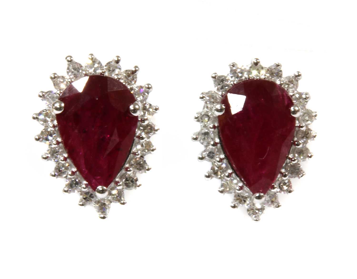 Lot 121 - A pair of white gold ruby and diamond halo cluster earrings