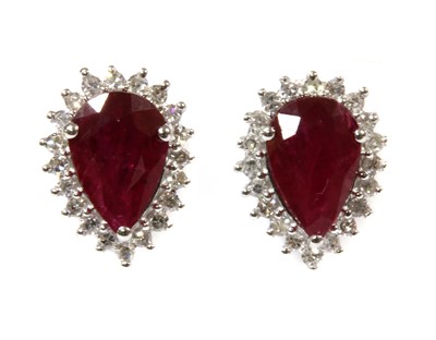 Lot 121 - A pair of white gold ruby and diamond halo cluster earrings