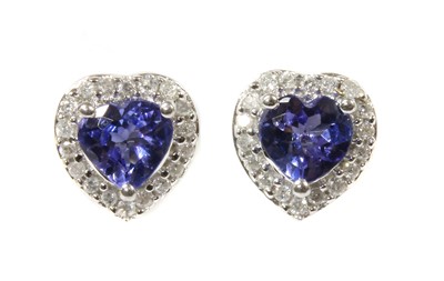Lot 245 - A pair of white gold tanzanite and diamond halo cluster earrings