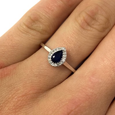 Lot 111 - A white gold sapphire and diamond cluster ring