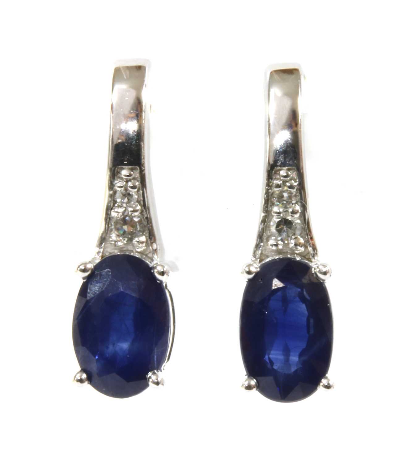 Lot 143 - A pair of white gold sapphire and diamond earrings