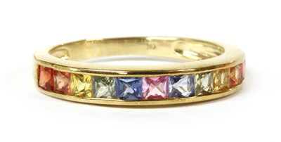 Lot 176 - A gold rainbow sapphire half eternity ring