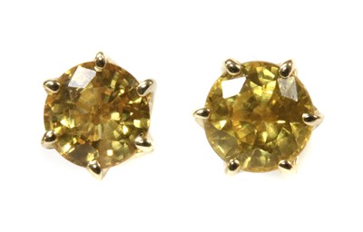 Lot 175 - A pair of gold single stone yellow sapphire stud earrings