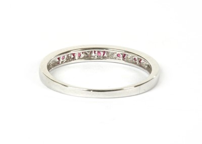 Lot 121 - A 9ct white gold ruby and diamond half eternity ring