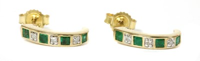 Lot 143 - A pair of 9ct gold emerald and diamond 'J' hoop earrings