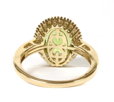 Lot 150 - A gold peridot and diamond cluster ring