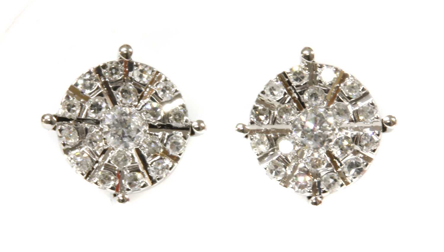 Lot 91 - A pair of white gold diamond cluster earrings
