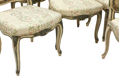 Lot 196 - A set of twelve French Louis XV-style carved and polychrome painted dining chairs