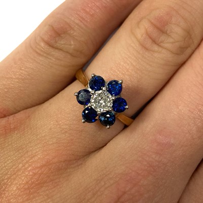 Lot 161 - An 18ct gold diamond and sapphire cluster ring