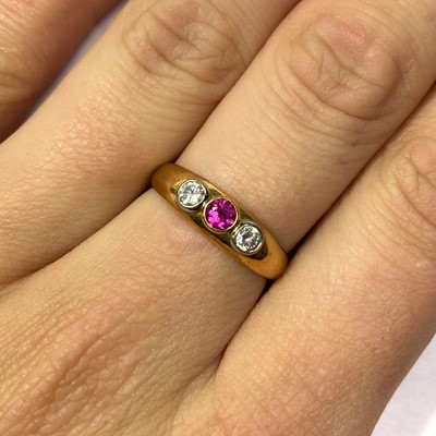 Lot 113 - An 18ct gold ruby and diamond three stone ring