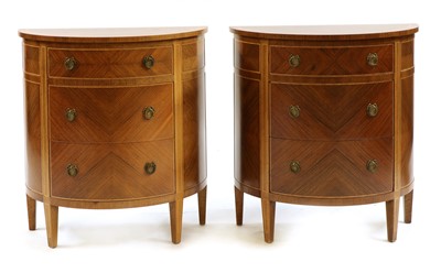 Lot 386 - A pair of walnut demilune three drawer commodes