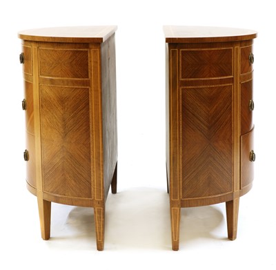 Lot 386 - A pair of walnut demilune three drawer commodes