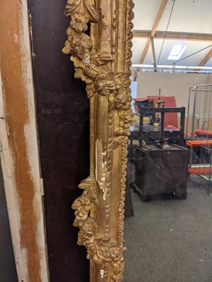 Lot 266 - A large carved giltwood wall mirror