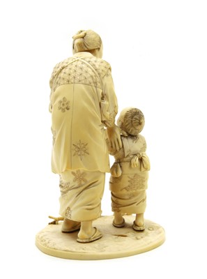 Lot 193 - A Japanese sectional carved ivory figure of a mother and child