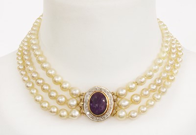 Lot 214 - A three row graduated cultured pearl necklace with an amethyst and diamond cluster clasp