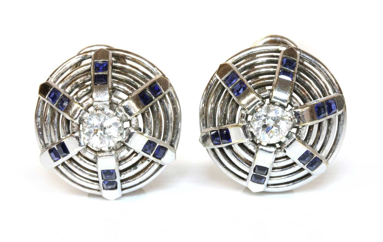 Lot 183 - A pair of white gold diamond and synthetic sapphire bombé earrings, c.1940
