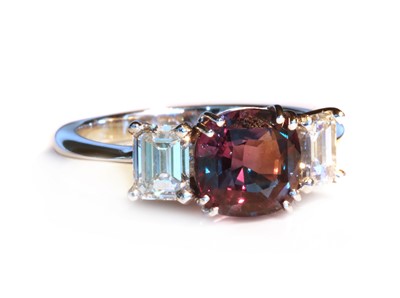Lot 412 - A white gold three stone colour change alexandrite and diamond ring