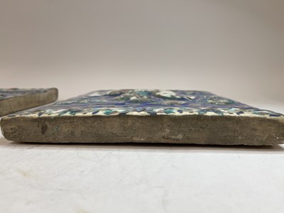 Lot 947 - A near pair of Qajar pottery tiles