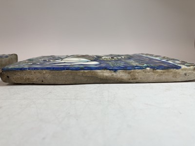 Lot 947 - A near pair of Qajar pottery tiles