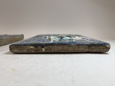 Lot 947 - A near pair of Qajar pottery tiles