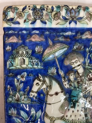 Lot 947 - A near pair of Qajar pottery tiles