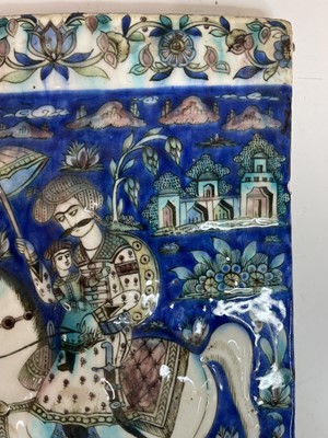 Lot 947 - A near pair of Qajar pottery tiles