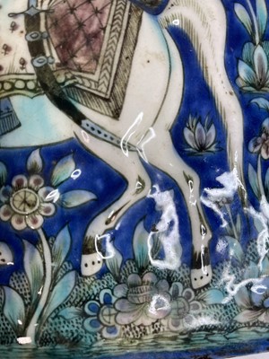 Lot 947 - A near pair of Qajar pottery tiles